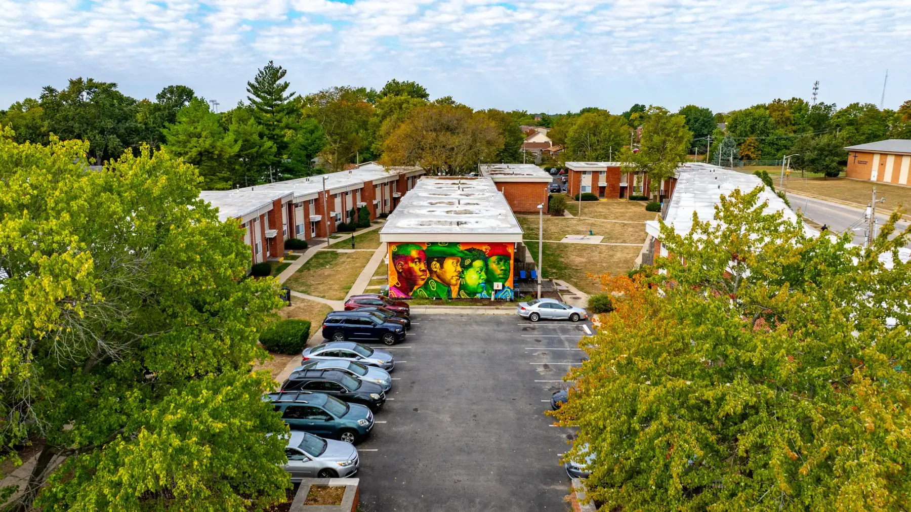 Aerial view of Westbury Townhomes at John Street and Mattis Avenue, surrounded by mature trees and west Champaign neighborhoods