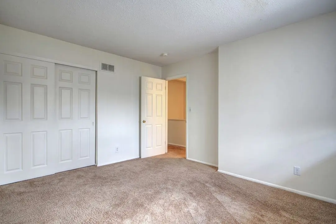 Carpeted bedroom with a wide double closet
