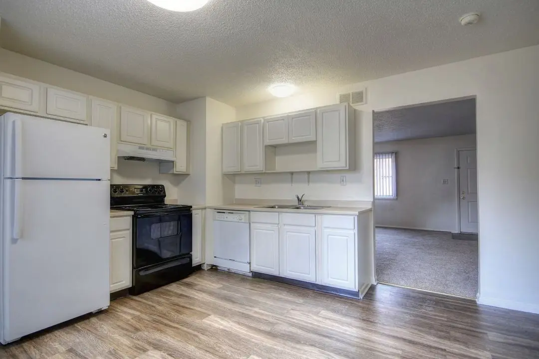 Kitchen with dishwasher and electric range, opening to the living room
